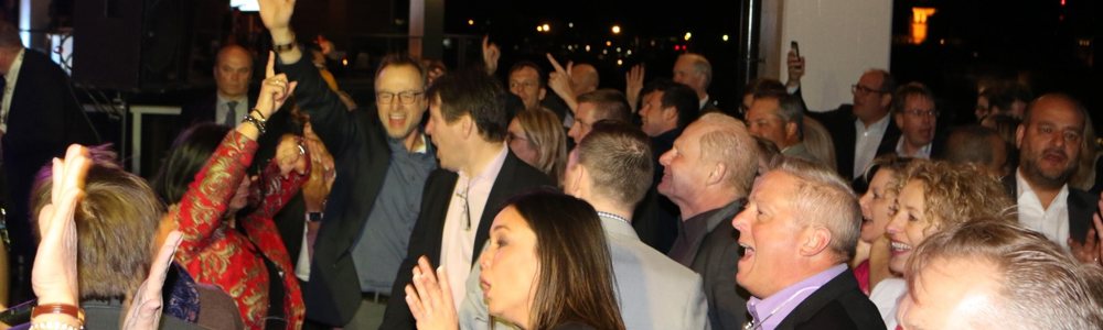 People having a blast from the corporate event entertainment they're experiencing. 